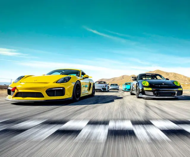 Photo of race cars crossing a checkered finish line.