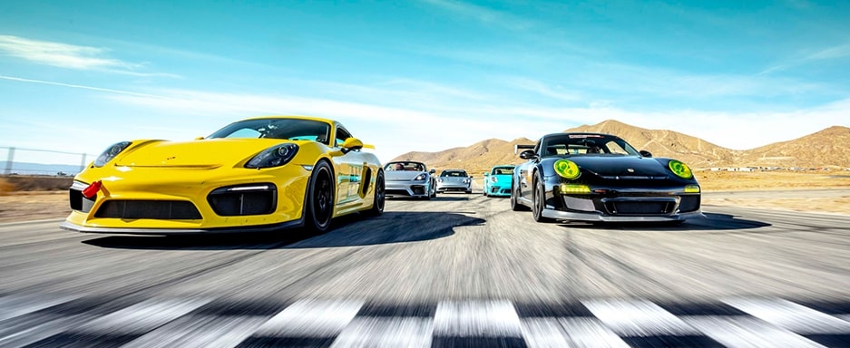 Photo of race cars crossing a checkered finish line.